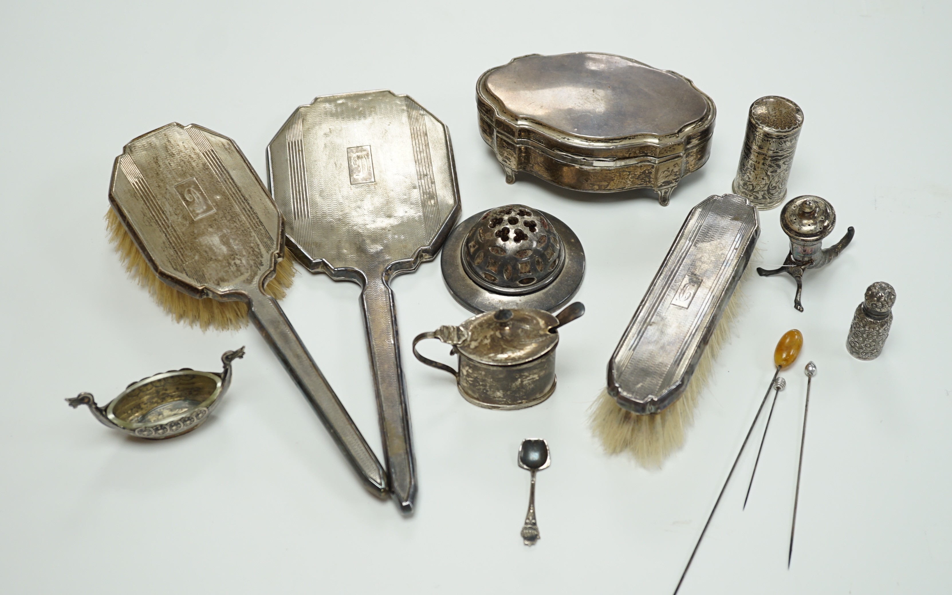 A George V silver mounted trinket box, Elkington & Co, Birmingham, 1918, 13.1cm, a silver mustard pot, two Scandinavian 925 condiments, two silver mounted scent bottles, hatpins and hatpin stand and a silver mounted thre